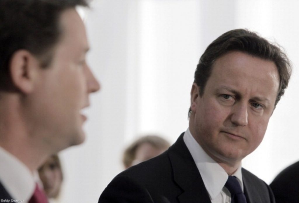 Cameron looks on at Clegg during a health reform Q&A last month