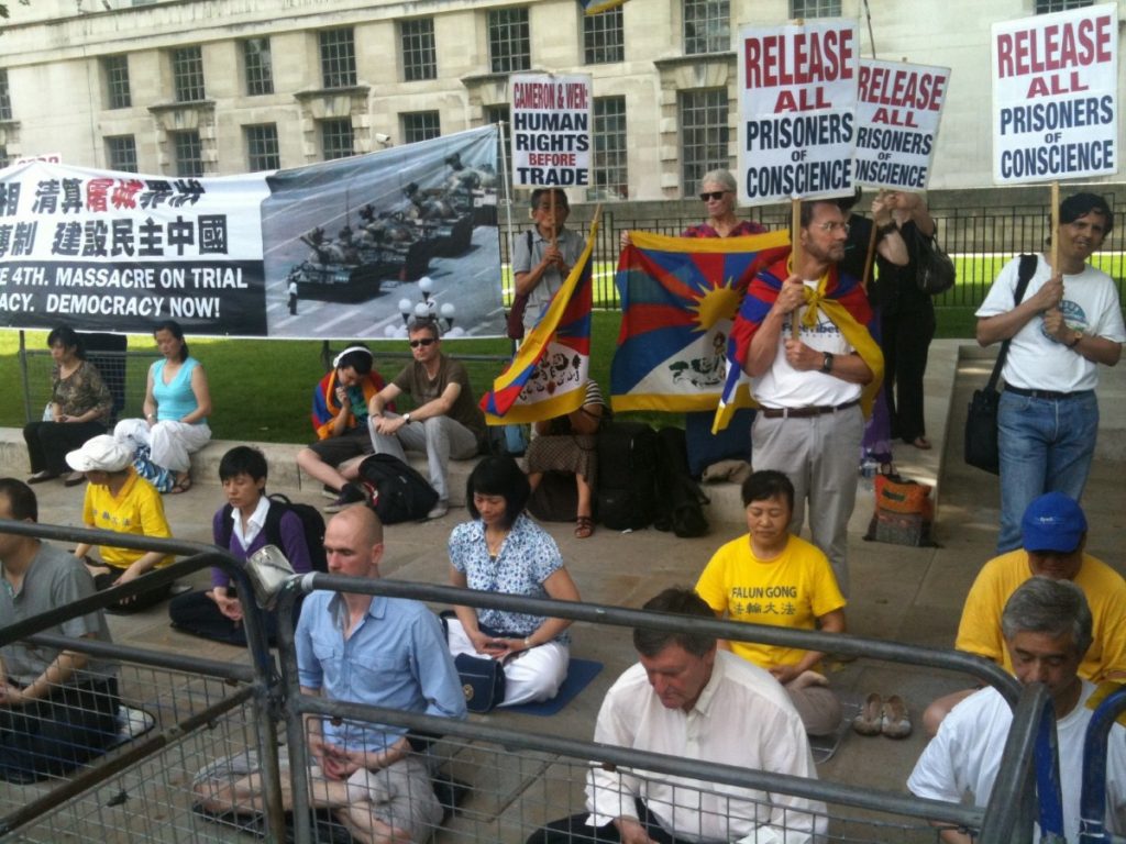 Free Tibet demonstrators meditate outside Downing Street during David Cameron