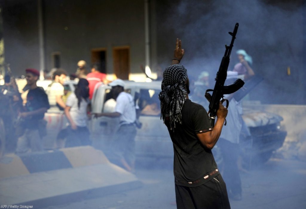 A Libyan rebel celebrates inside the captured military base, 