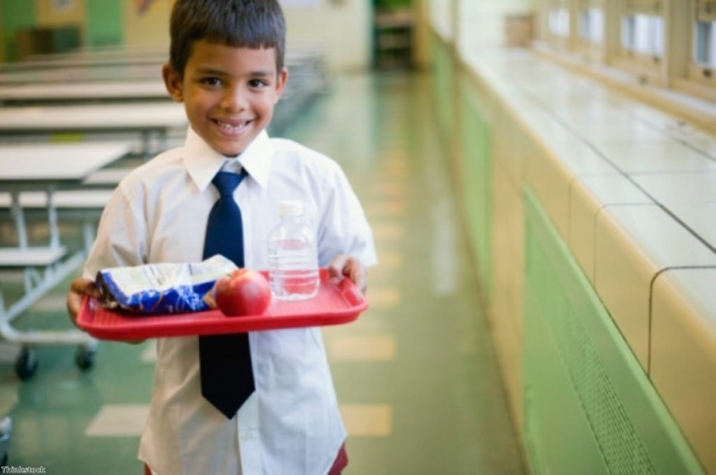 A schoolboy poses with his lunch: Farage has been accused of politicising the pork incident