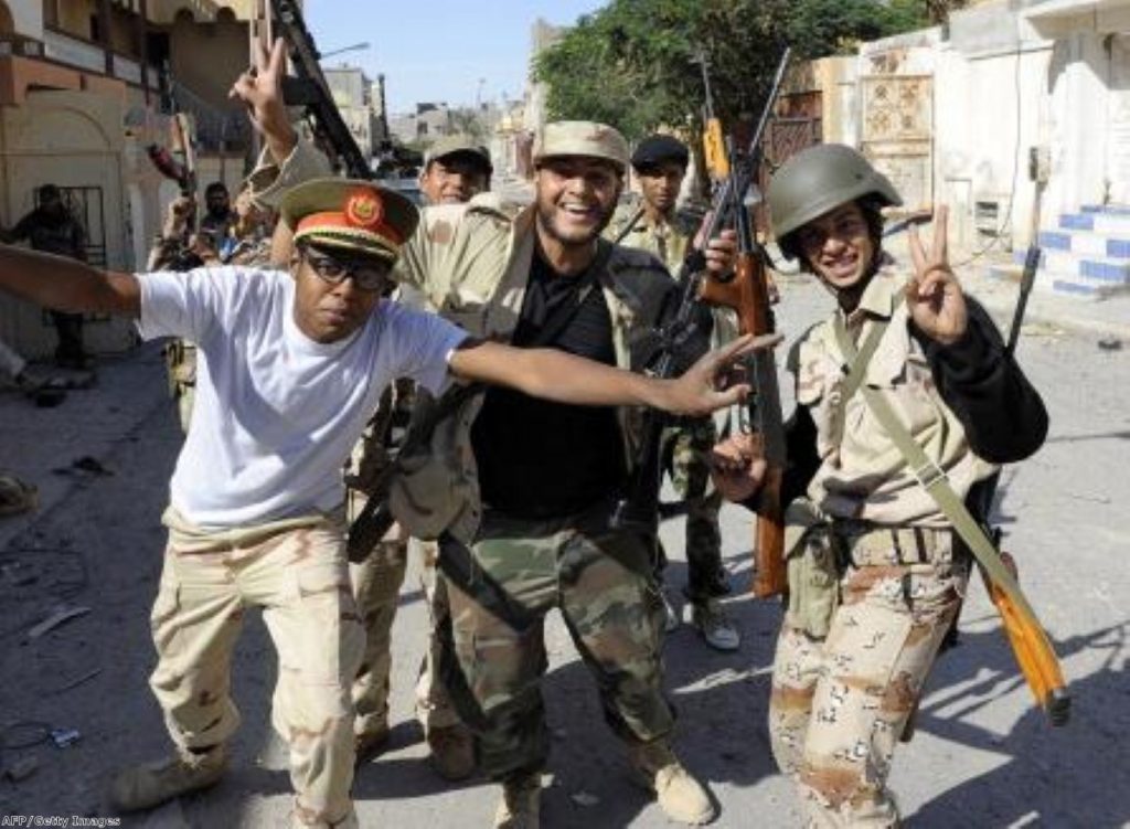 Libyan NTC troops celebrate Muammar Gaddafi