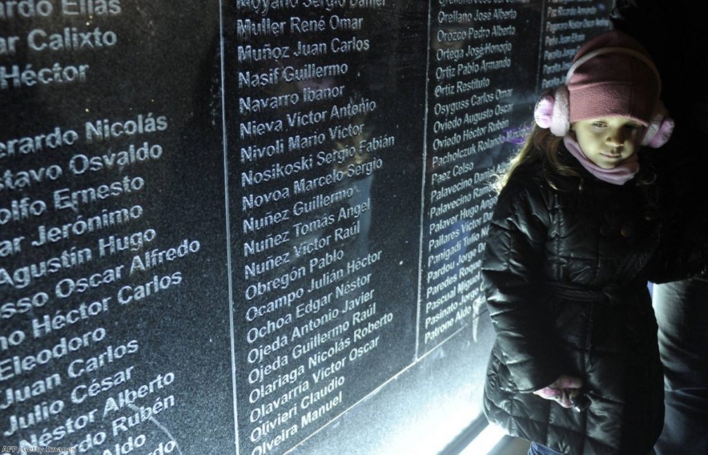 A girl walks past the Falklands Memorial during anniversary commemorations in Ushuaia, Tierra del Fuego this morning