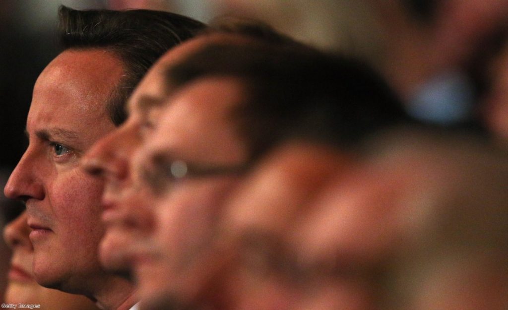 Cameron sits in the auditorium during the conference yesterday.