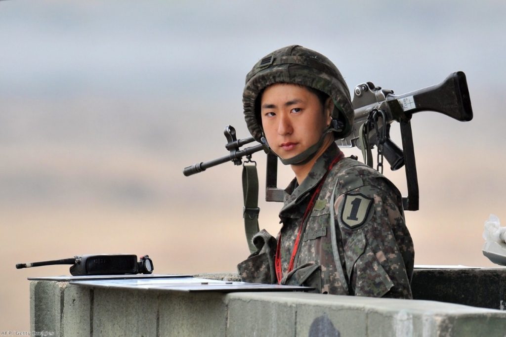 A South Korean soldier stands on a military guard post near the demilitarized zone (DMZ) dividing the two Koreas in the border city of Paju on April 5, 2013. 