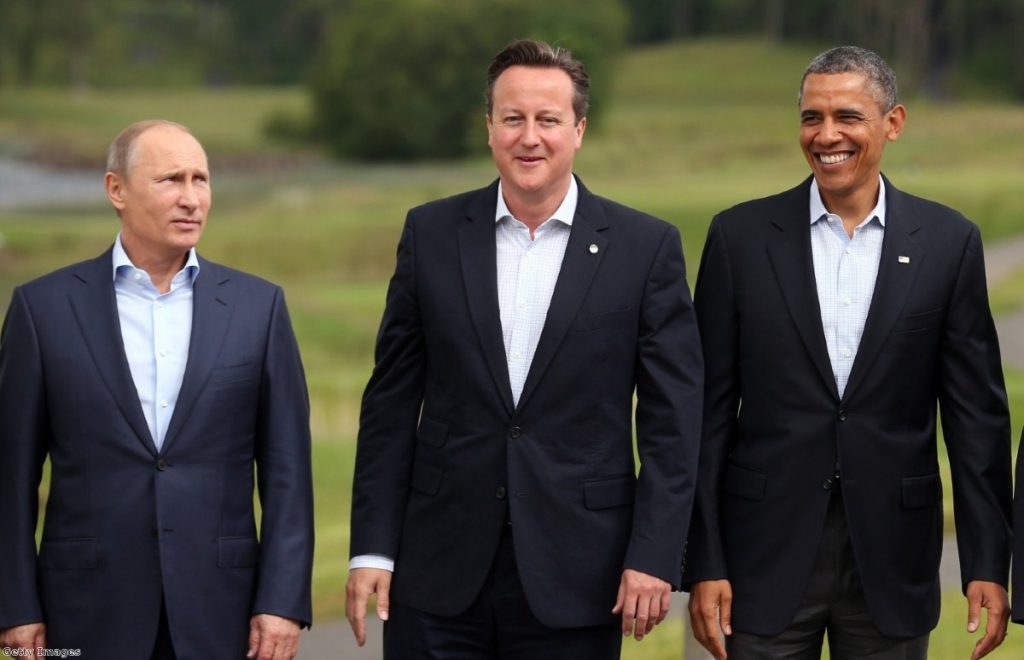 Odd man out? Putin strikes a glum look as Cameron and Obama share a smile 