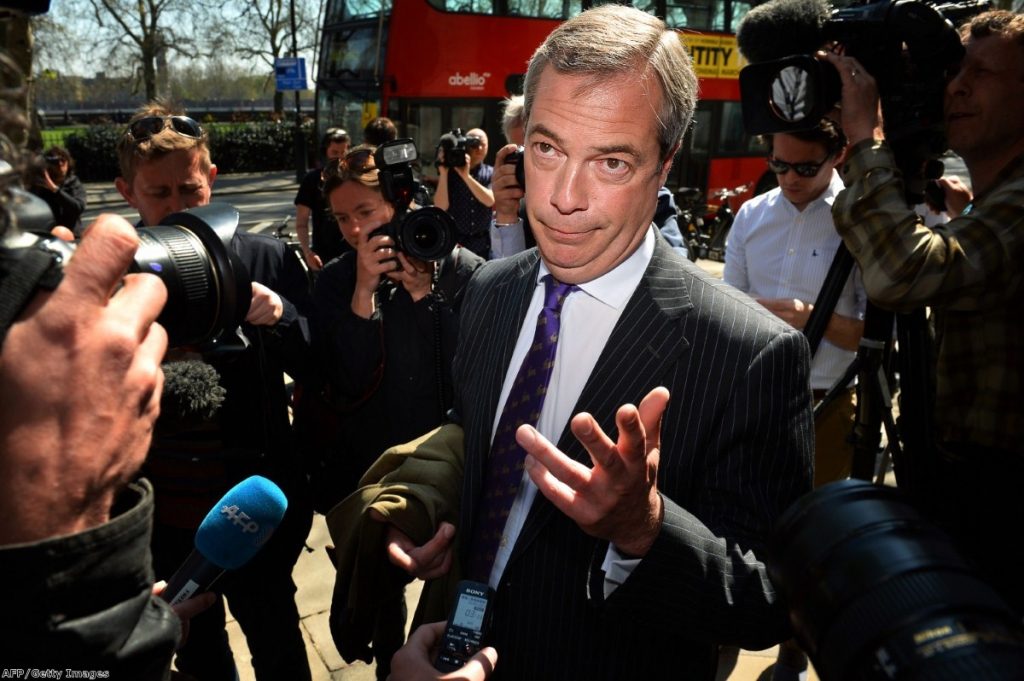 Farage struggles to speak to the press during a walk about in London 