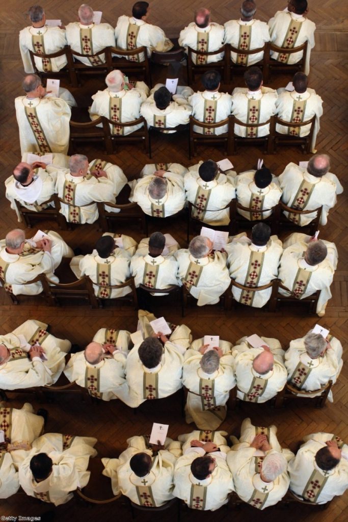 Priests wear their new clerical vestments during the annual Chrism Mass in Westminster Cathedral. The Church