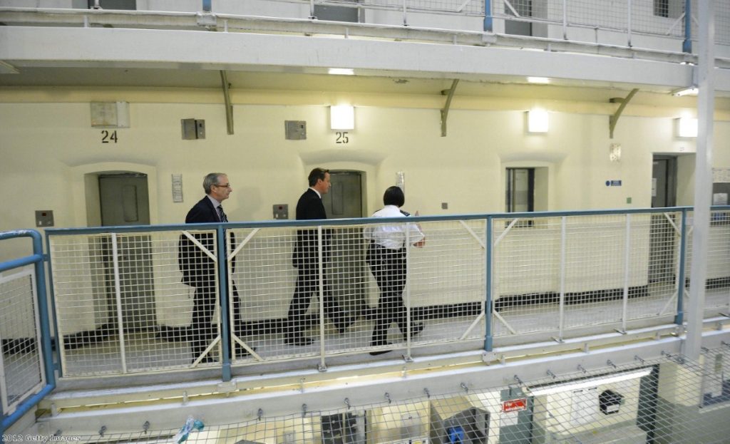 David Cameron is escorted around the Scrubs in 2012. Since then suicides at the prison have shot up. 