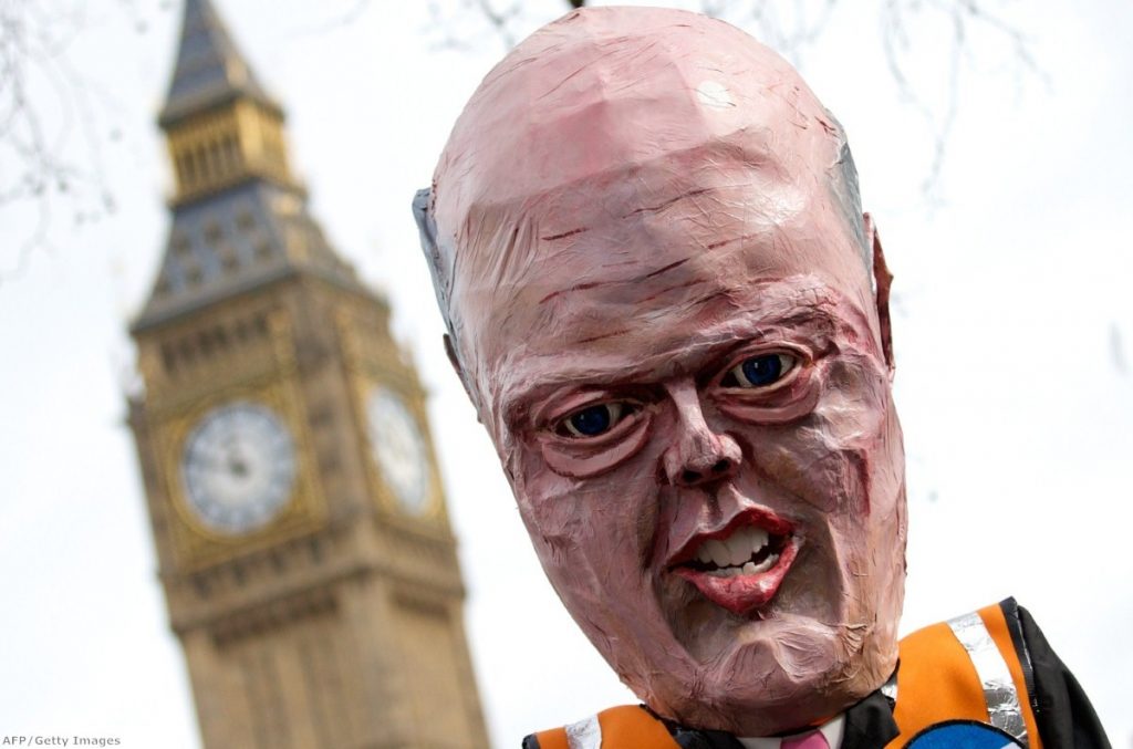 A puppet representing Chris Grayling is held aloft during a demonstration against planned cuts to legal aid last month 