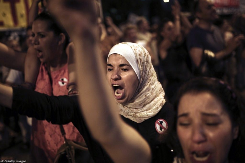 A protester shouts slogans outside the US embassy in Athens during a demonstration against Israel