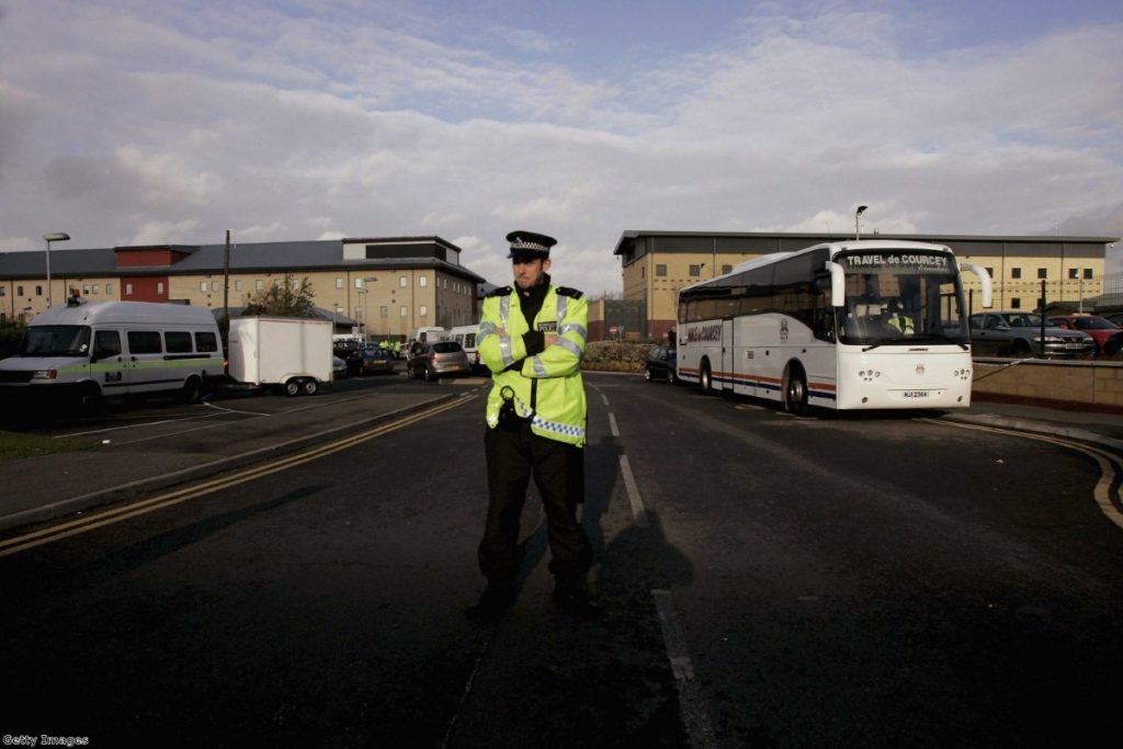 A police officer stands guard at the entrance to Harmondsworth following clashes between police and detainees in 2006   