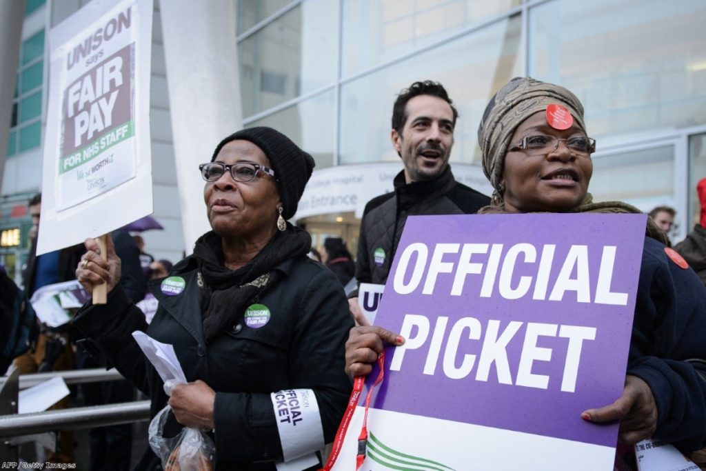 NHS workers strike outside University College Hospital in central London 