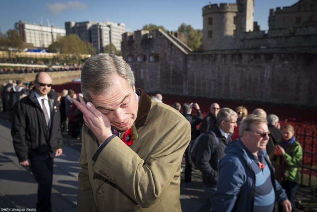 Farage wipes a tear from his eye after visiting the poppy exhibit at the Tower of London 