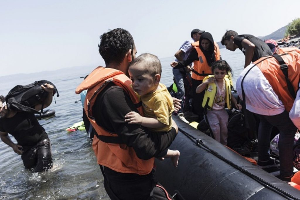 Migrants arrive on a beach of the Greek island of Lesbos, after crossing the Aegean Sea between Turkey and Greece, 