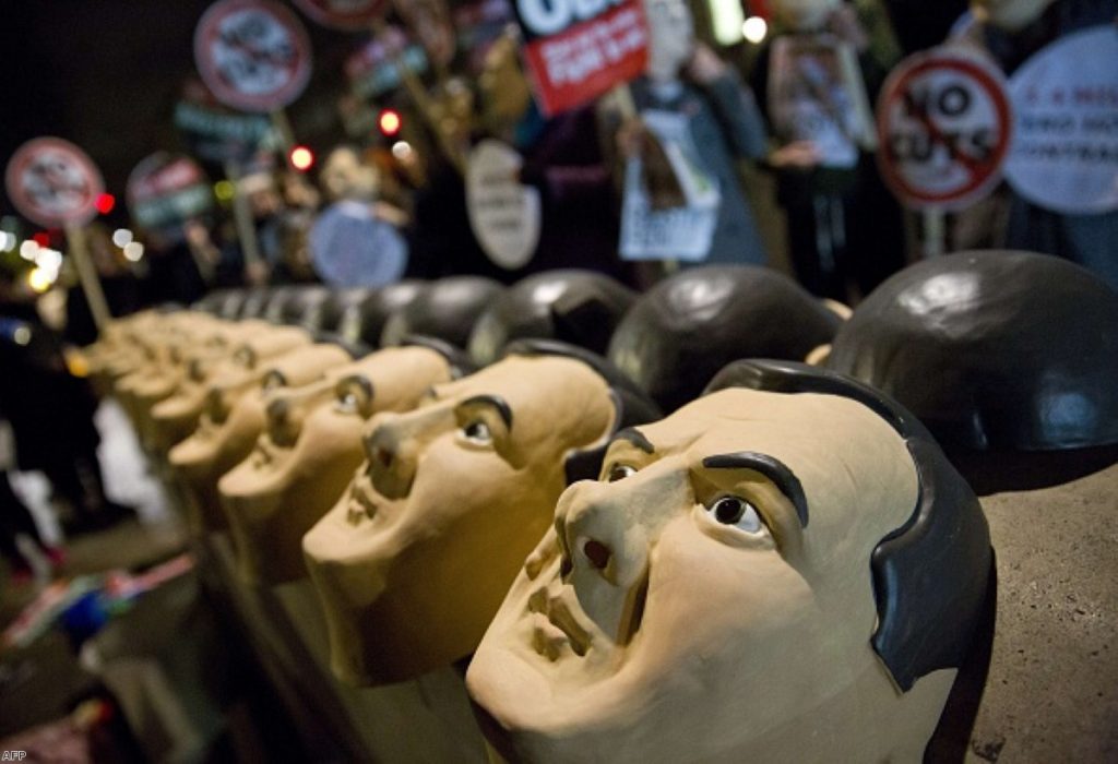 Rubber masks of British Chancellor George Osborne are lined up by Anti-austerity protesters last year