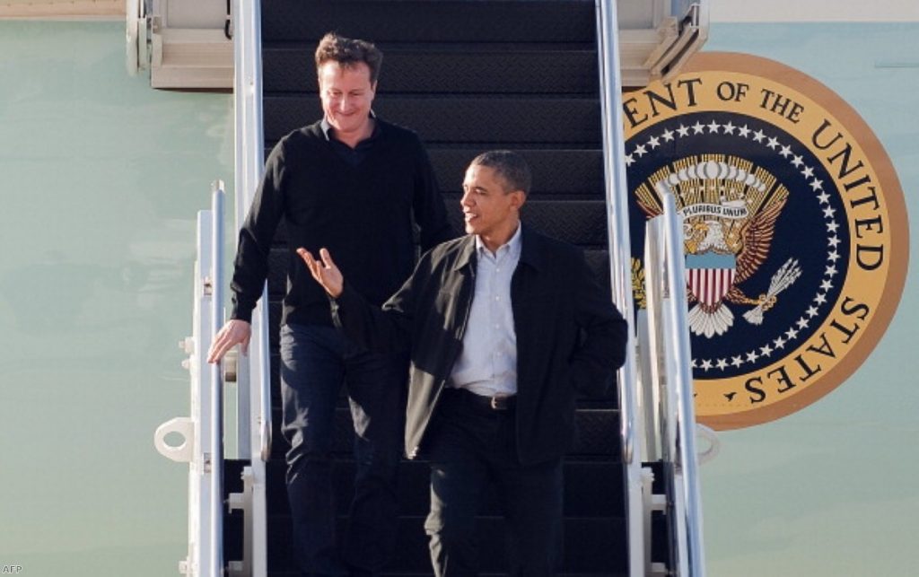 David Cameron looks on admiringly as Barack Obama leads him off Air Force One