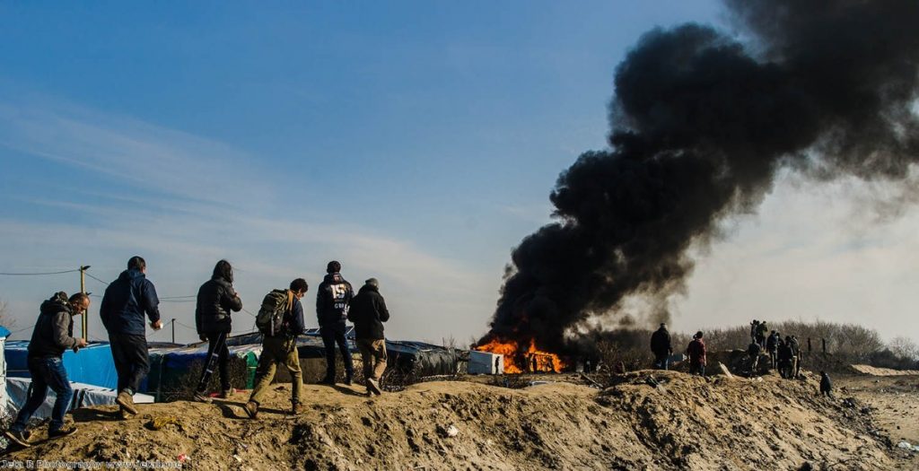 Caroline Lucas: "Smoke and flames rose sporadically into the sky as parts of the camp burn"