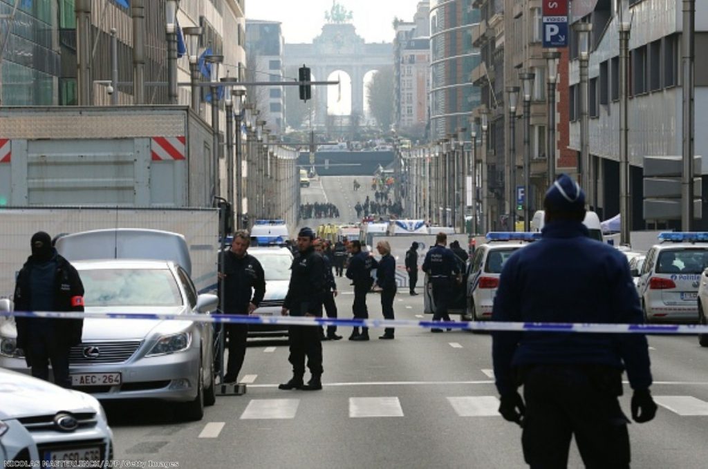 Police stand guard near a security perimeter in the Rue de la Loi near the Maalbeek subway station, in Brussels, after an explosion 