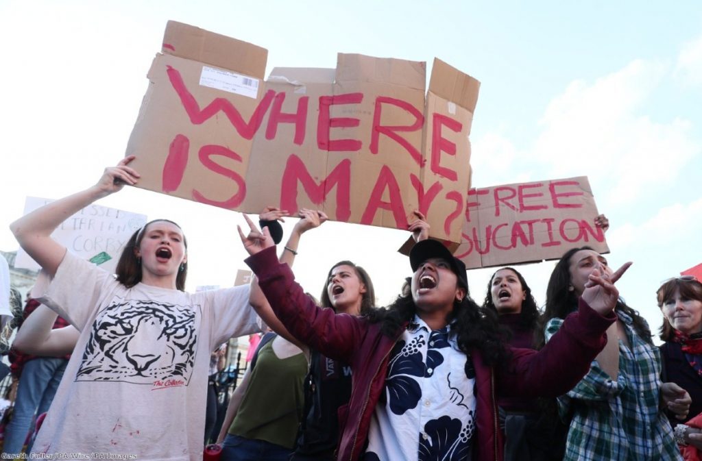 Protestors and supporters watch the arrival of the politicians who are taking part in the BBC Election Debate