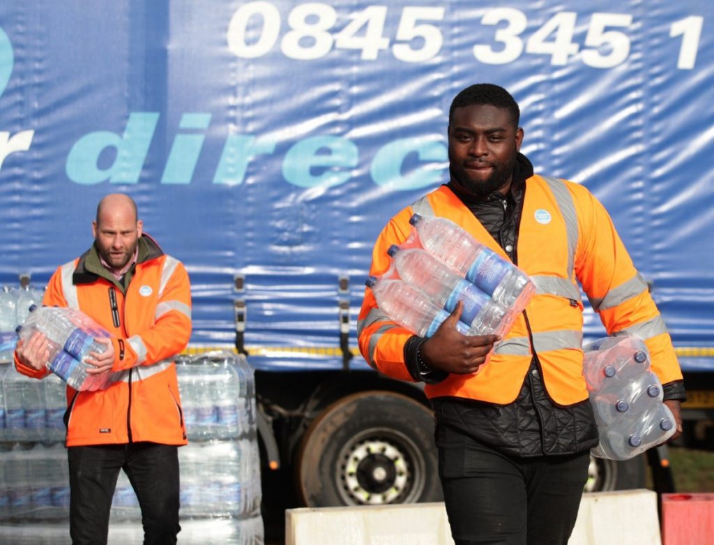 Thames Water workers help distribute bottled water in Hampstead, north London, after thousands of people were left without water. 