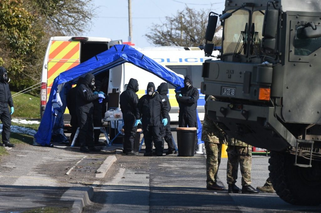 Police and army personnel suit up on Larkhill Road in Durrington, Salisbury, during the investigation into the attack on Sergei and Yulia Skripal  