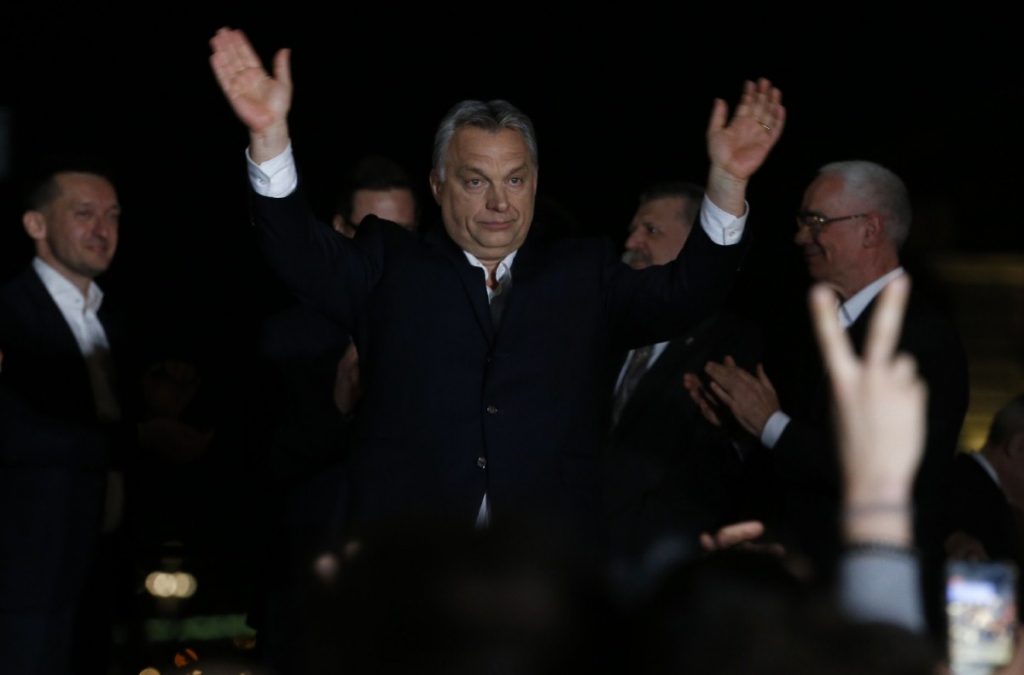 Hungarian prime minister Viktor Orban greets supporters in Budapest last night as preliminary results start coming through. 