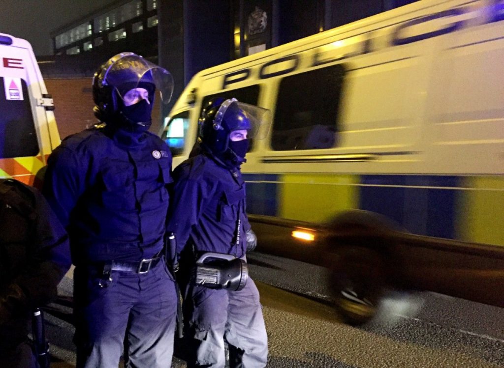 Police officers stand outside HMP Birmingham in December 2016 after a disturbance. A specialist riot squad known as the Tornado Team were deployed to quell the trouble. Copyright: PA. 