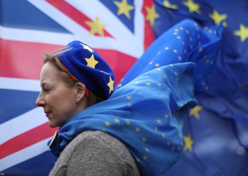 An anti-Brexit protester stands outside of parliament, on another day of high Commons drama 