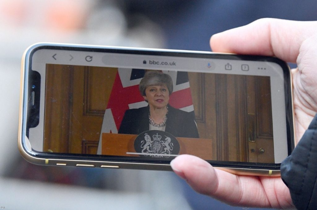 A journalist watches the prime minister