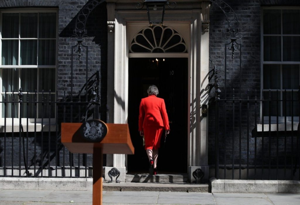 Theresa May walks back into Downing Street after announcing her resignation this morning. 