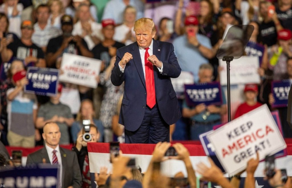 President Donald Trump works the crowd during a campaign rally at East Carolina University, where chants of 