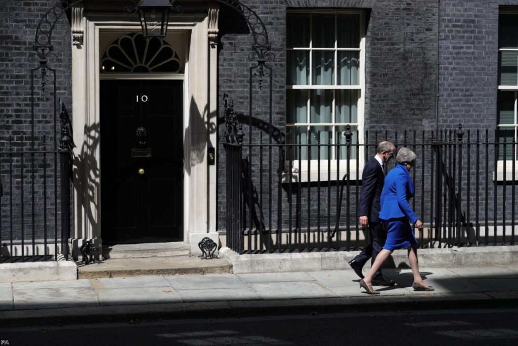 Departure: May leaves Downing Street for the last time with her husband  