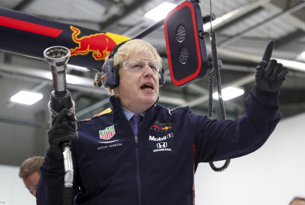 Boris Johnson prepares to change a wheel during a visit to Red Bull Racing facility in Milton Keynes. He has been accused of lying and evasiveness during the campaign. 