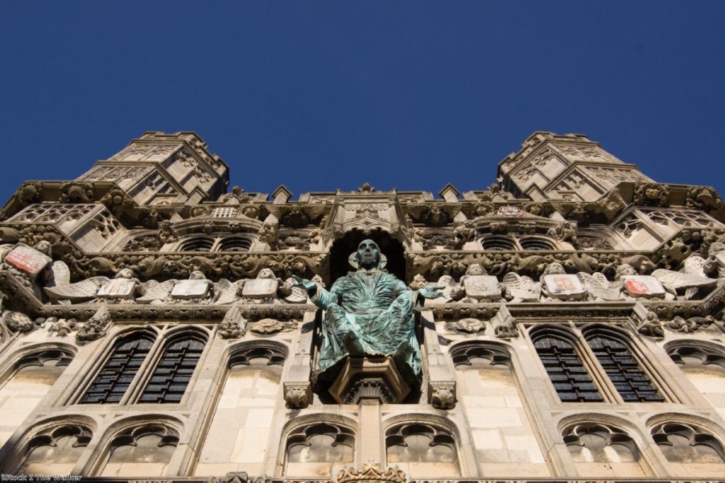 Weighed in the balance: Ornaments on the entrance to Canterbury cathedral area. 