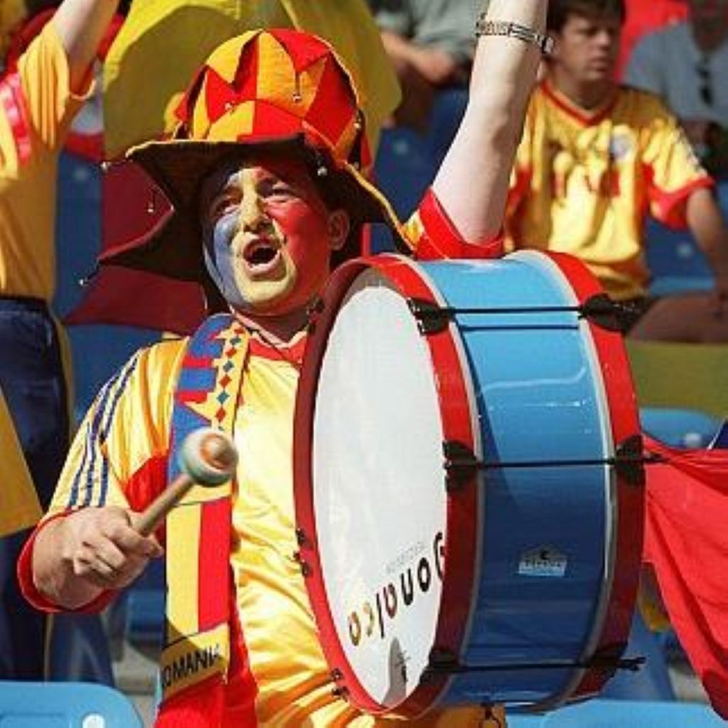 A Romanian fan beats the drum for his team. In December, controls on Romanian movement within the EU will be lifted. 