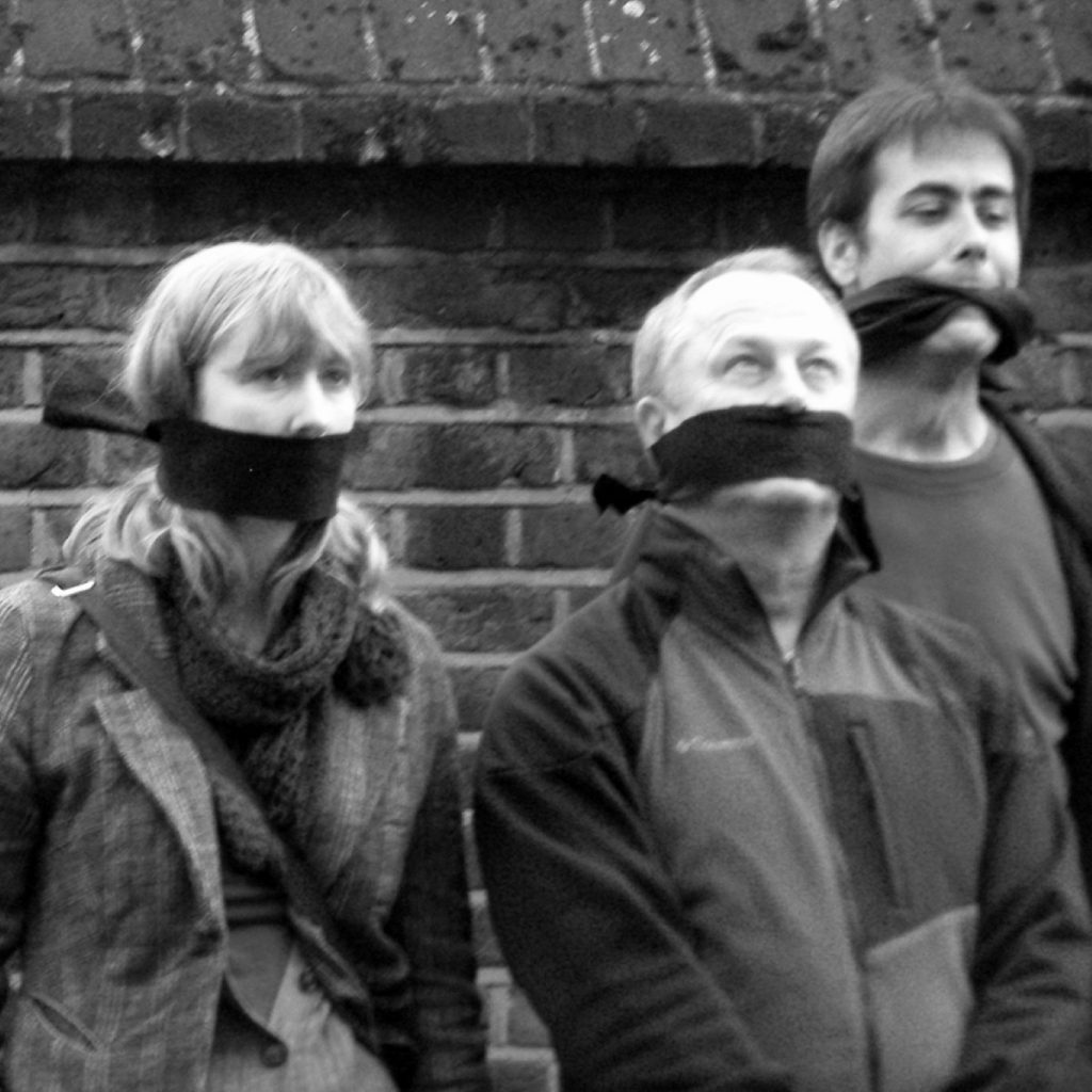 Protestors gag themselves outside the offices of Carter Ruck, Trafigura's lawyers, to dispute the use of super-injunctions