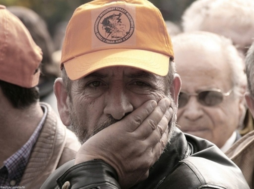 A striker looks on during industrial action in Greece. The Mediterranean country has been the worst hit so far.