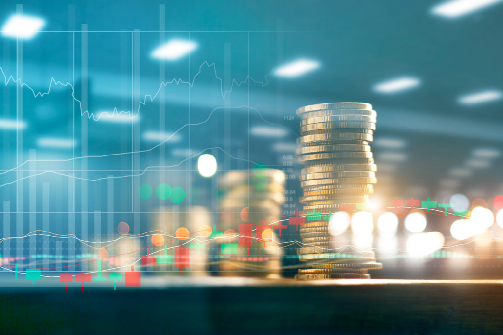 Finance and business investment concept. Graph and rows with statistic growth of coins on table.