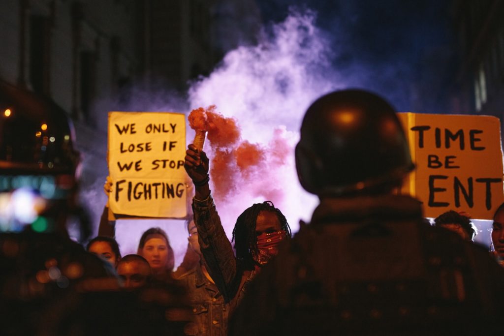 Group of activists protesting with smoke grenades